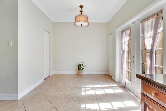 unfurnished dining area with crown molding and light tile patterned flooring