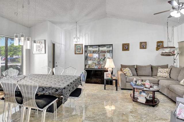 dining room featuring vaulted ceiling, a textured ceiling, and ceiling fan