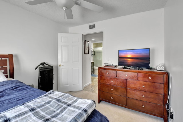 carpeted bedroom with a textured ceiling and ceiling fan