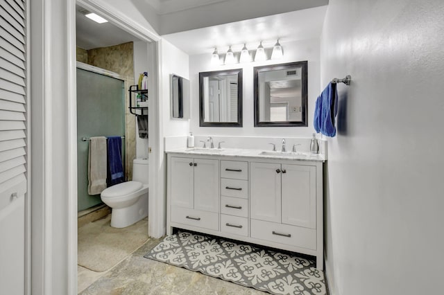 bathroom featuring vanity, toilet, and walk in shower