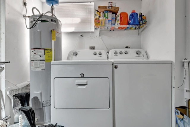 laundry area with independent washer and dryer and electric water heater