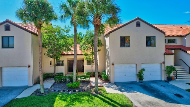 mediterranean / spanish-style home with a garage