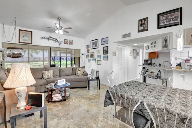 living room featuring high vaulted ceiling and ceiling fan