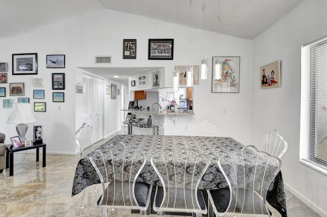 dining space with lofted ceiling