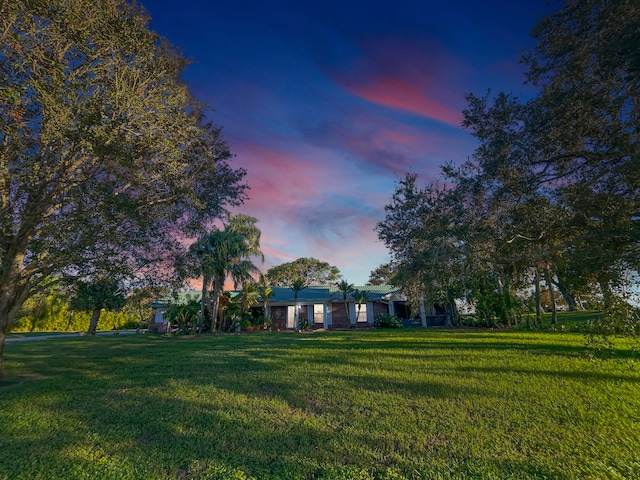 view of side of home featuring a lawn, a garage, and an outdoor structure