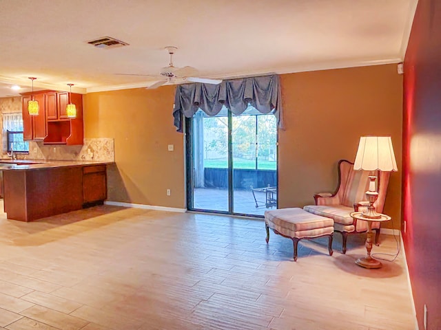 kitchen with tasteful backsplash, light hardwood / wood-style flooring, a wealth of natural light, and crown molding