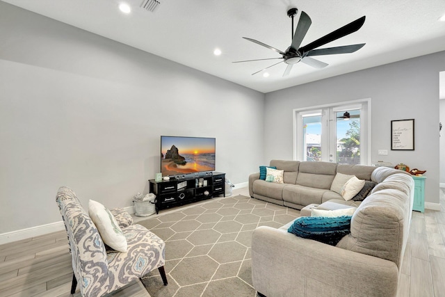 living room featuring light hardwood / wood-style floors and ceiling fan