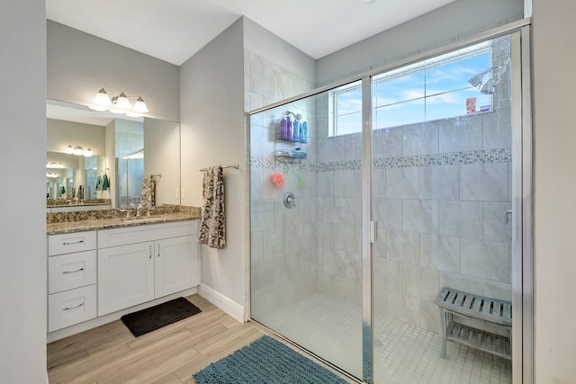 bathroom featuring vanity, hardwood / wood-style flooring, and walk in shower