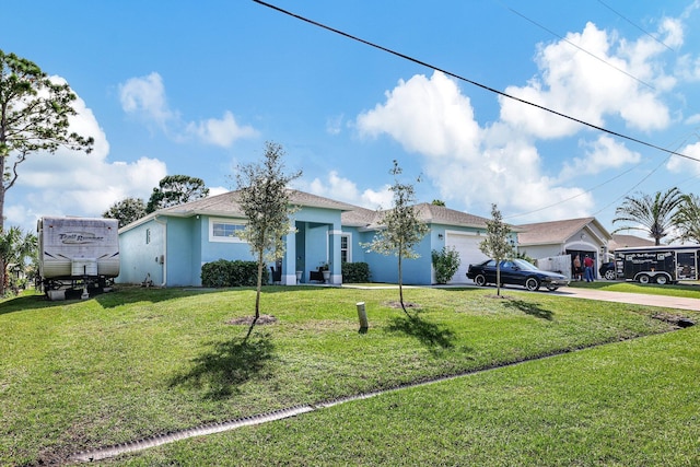 ranch-style house featuring a front lawn and a garage