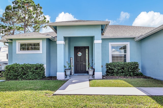 doorway to property featuring a yard