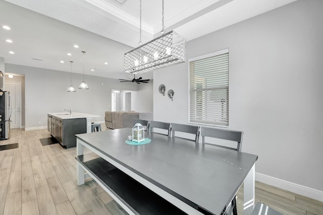 dining area with sink, light hardwood / wood-style flooring, and ceiling fan