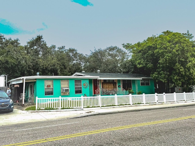 ranch-style home with covered porch and cooling unit