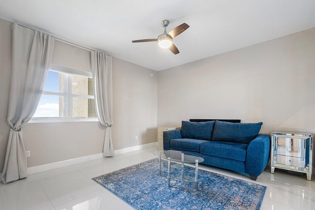 sitting room featuring ceiling fan and tile patterned flooring