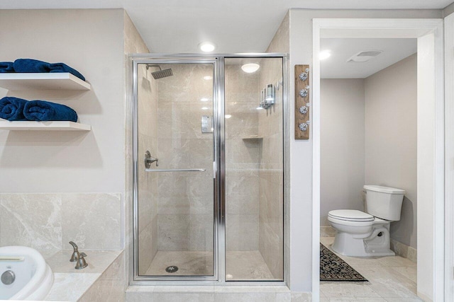 bathroom featuring toilet, plus walk in shower, and tile patterned flooring