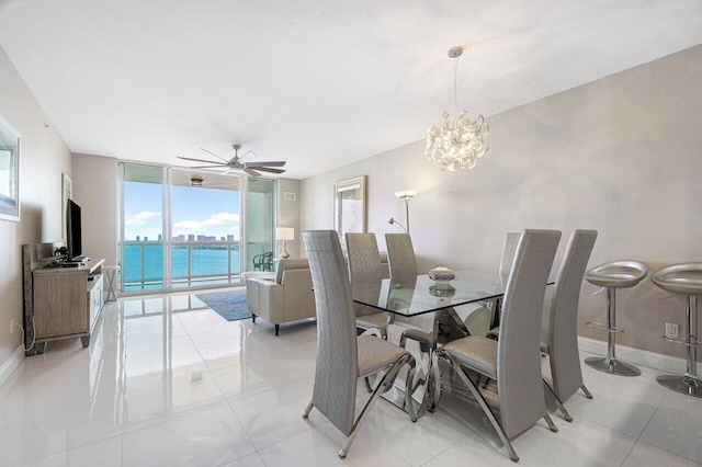 dining area with expansive windows, light tile patterned floors, and ceiling fan with notable chandelier