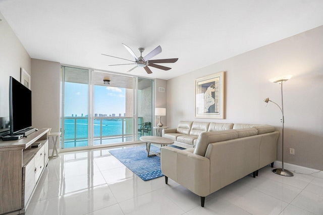 living room with expansive windows, light tile patterned flooring, and ceiling fan