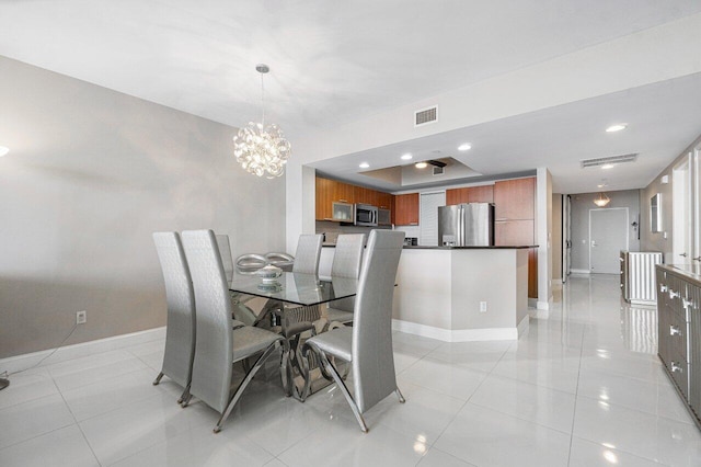 tiled dining room with a notable chandelier