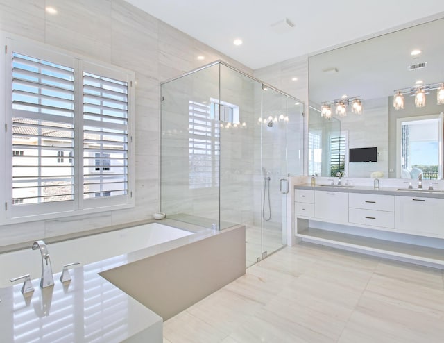 bathroom featuring vanity, tile walls, and a healthy amount of sunlight