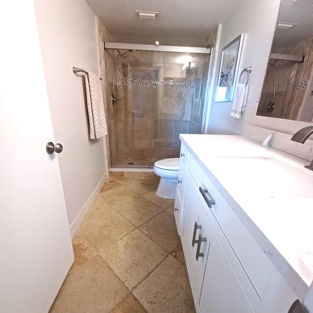 full bath featuring toilet, a stall shower, baseboards, and vanity