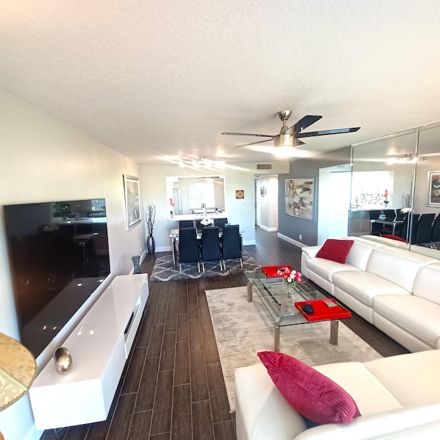 kitchen with wood-type flooring, backsplash, stainless steel fridge, white cabinets, and light stone counters