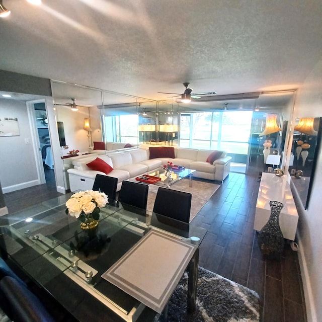 dining space with baseboards, a ceiling fan, a textured ceiling, and wood finish floors