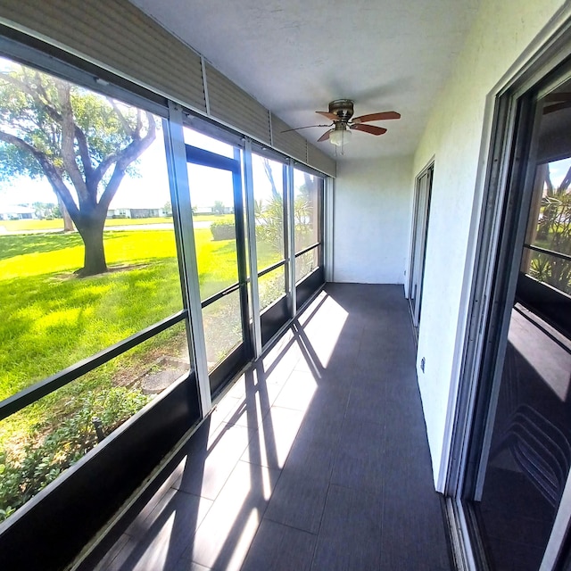 sunroom / solarium featuring ceiling fan