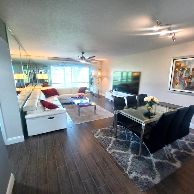 living room featuring dark hardwood / wood-style floors and ceiling fan