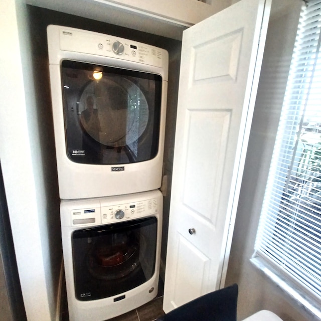 clothes washing area featuring stacked washer / dryer