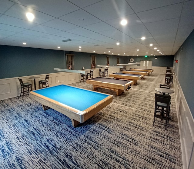 rec room with billiards, a drop ceiling, a wainscoted wall, carpet floors, and recessed lighting