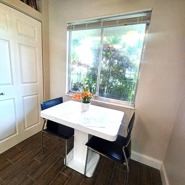 dining area featuring breakfast area, wood finish floors, and baseboards