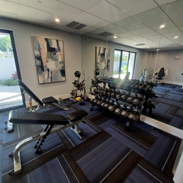 gym with a paneled ceiling