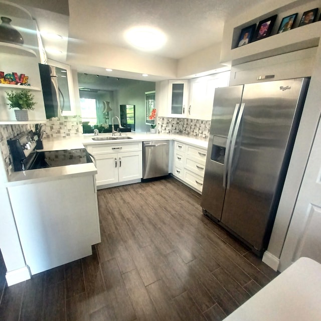 kitchen featuring stainless steel appliances, light countertops, white cabinetry, open shelves, and a sink