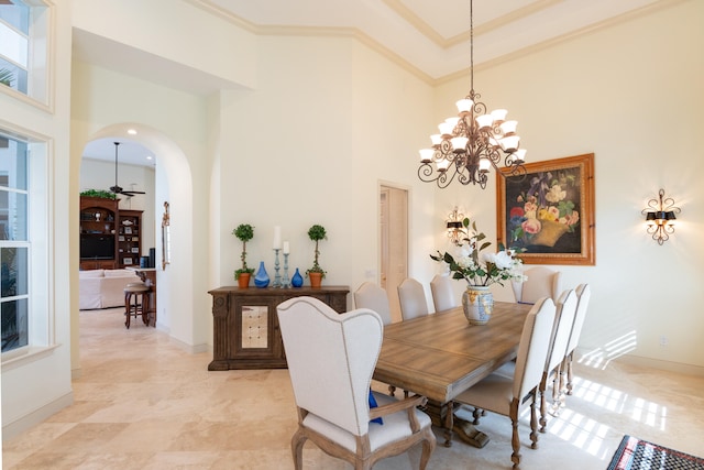 dining area with ornamental molding, a high ceiling, and a chandelier