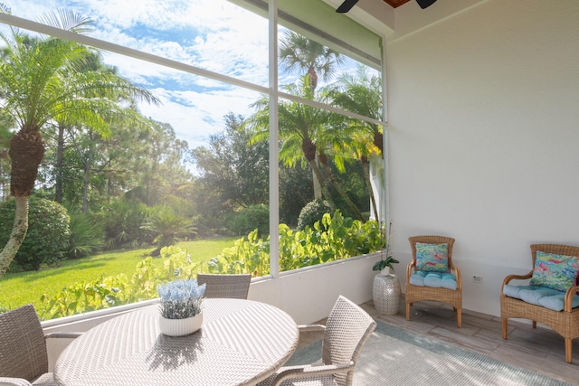 sunroom featuring ceiling fan and a healthy amount of sunlight