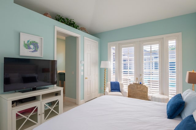 tiled bedroom with a closet