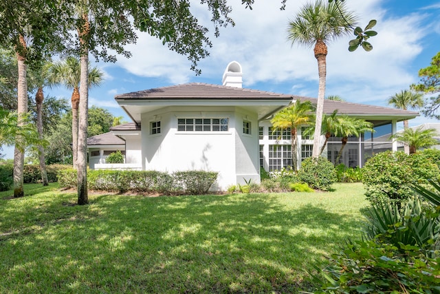 rear view of property featuring a yard