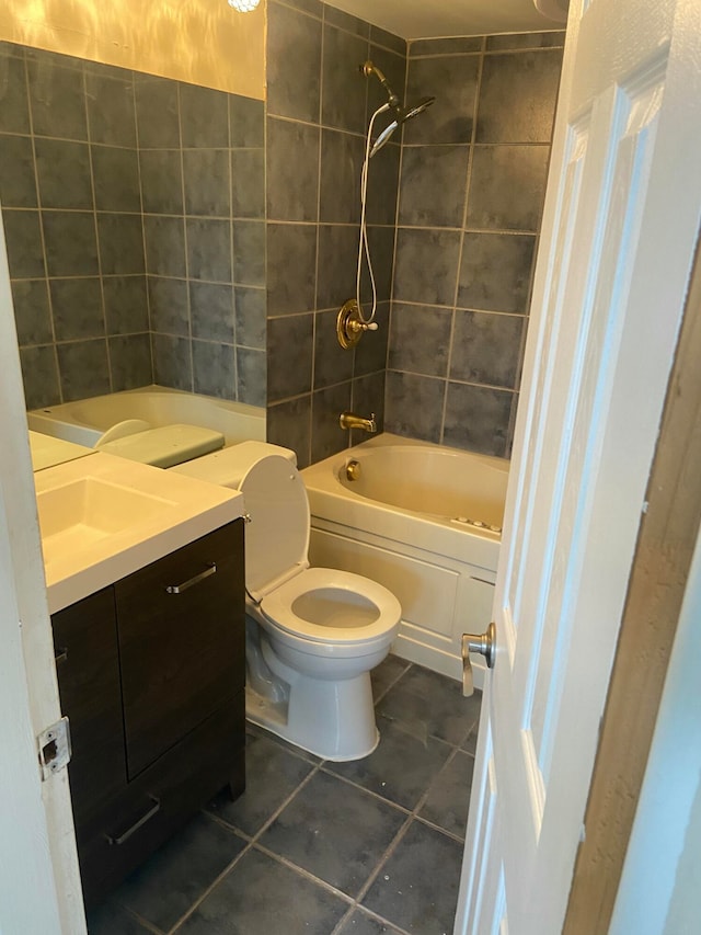 full bathroom with vanity, toilet, tiled shower / bath combo, and tile patterned flooring