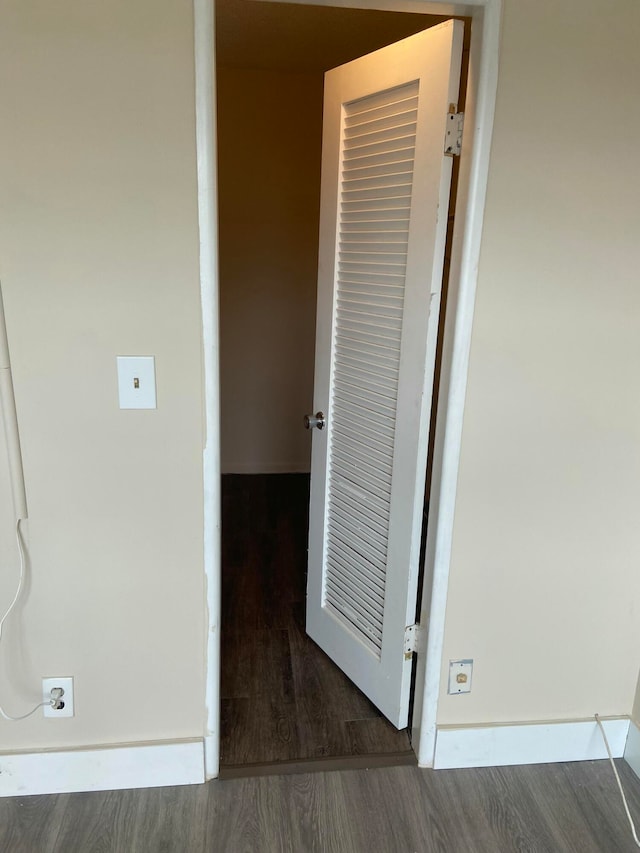 corridor featuring dark hardwood / wood-style floors