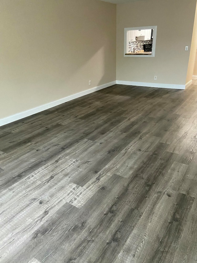 spare room with dark wood-type flooring