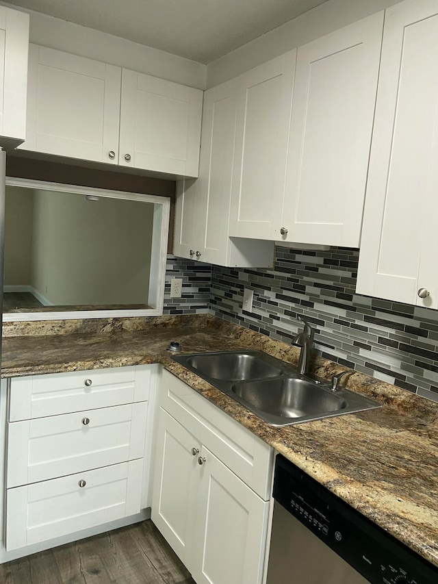 kitchen featuring dark stone countertops, dark hardwood / wood-style flooring, stainless steel dishwasher, and white cabinets