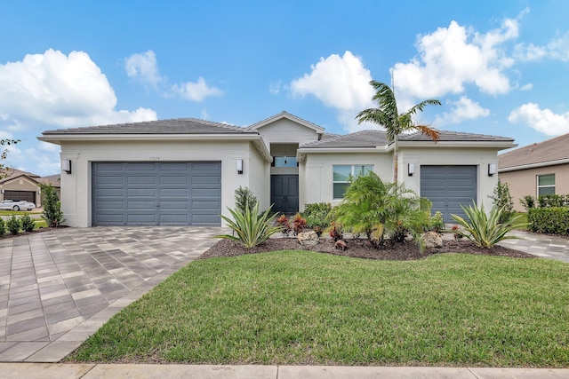 view of front of home with a front lawn and a garage