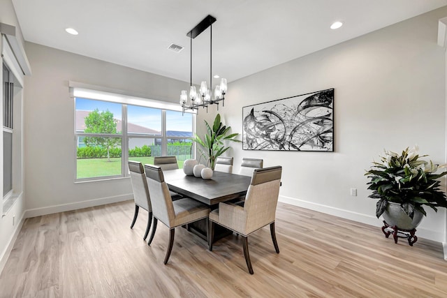 dining room featuring a chandelier and light hardwood / wood-style floors