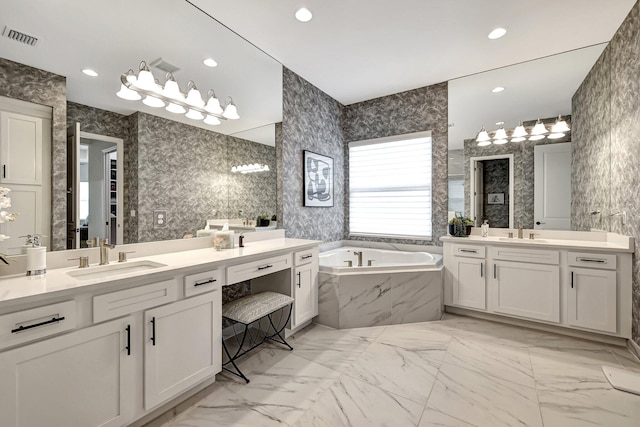 bathroom featuring vanity and a relaxing tiled tub