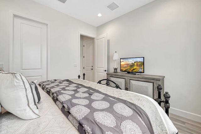 bedroom with wood-type flooring