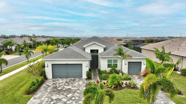 view of front of property with a front lawn and a garage