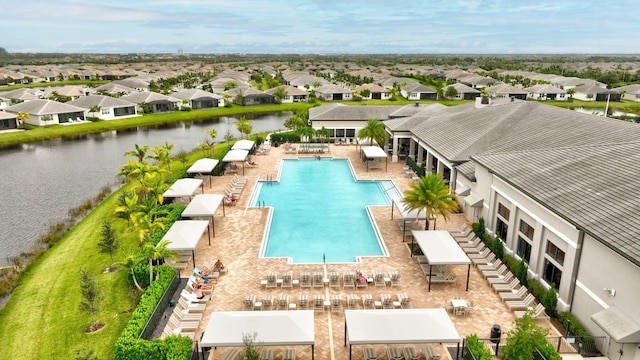 view of swimming pool featuring a water view and a patio