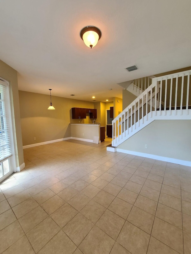 unfurnished living room featuring light tile patterned floors