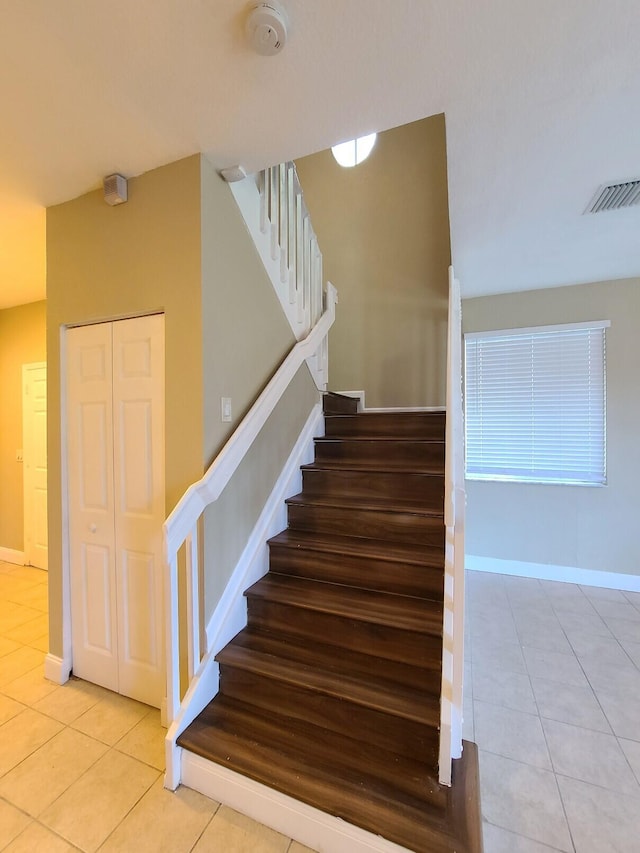 staircase with tile patterned flooring