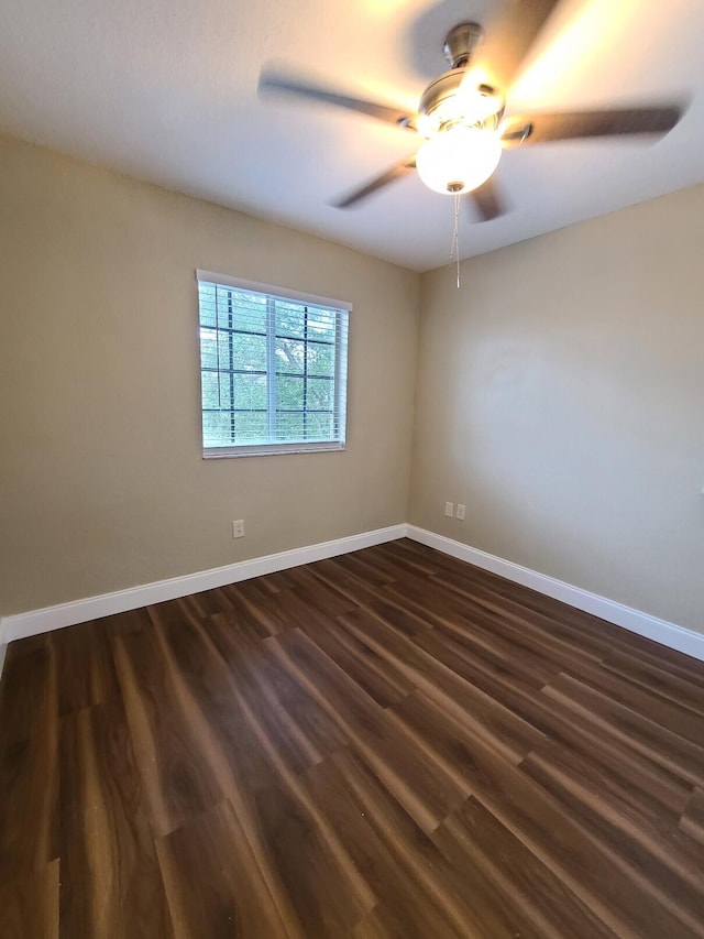 spare room featuring dark hardwood / wood-style floors and ceiling fan