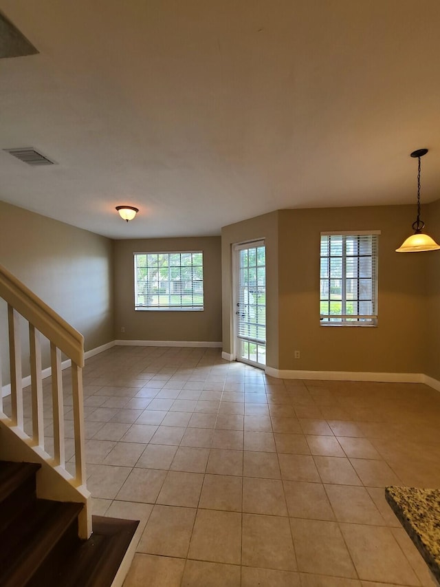 spare room featuring light tile patterned floors